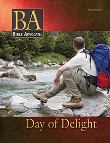 Traveler with backpack sits by a scenic river on Bible Advocate magazine cover, May-June 2015 edition, titled Day of Delight.