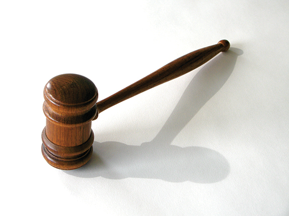 Wooden gavel on white background, symbolizing justice and law. Ideal for legal or auction-related content.