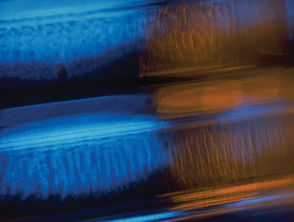 Abstract blue and orange light streaks create a dynamic and vibrant visual pattern, conveying motion and energy.