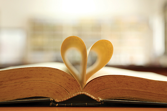 Open book with pages forming a heart shape, symbolizing the love for reading and literature.