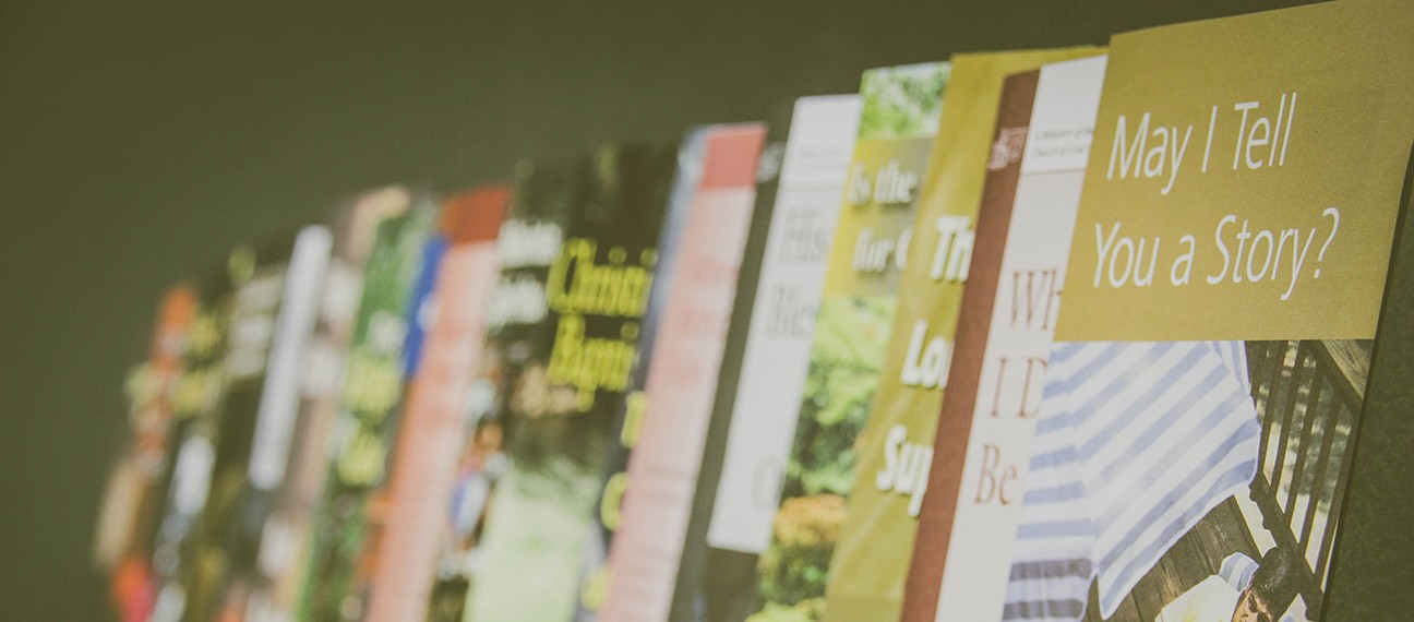 Rows of colorful books on display, the closest cover reads: May I Tell You a Story? Perfect for book lovers and readers.