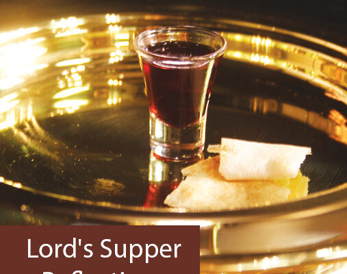 Communion elements on a tray: red wine in glass, piece of bread, with text Lord's Supper Reflections.