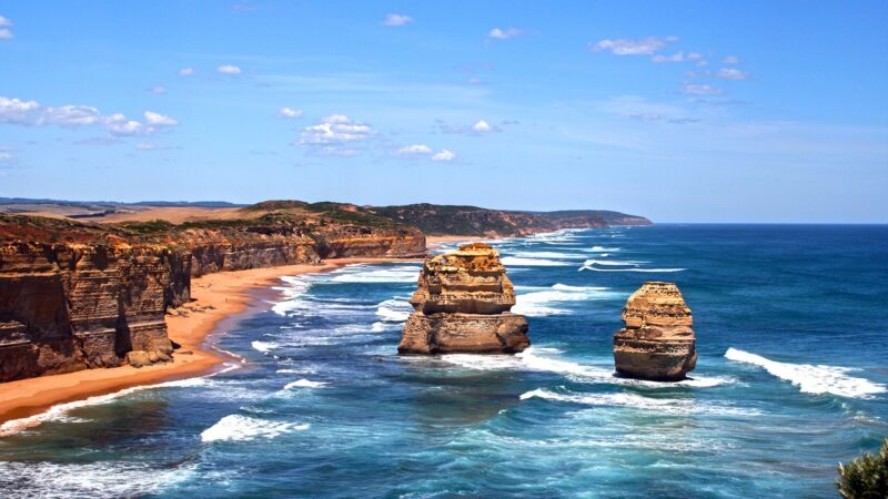 Stunning coastal view of rugged cliffs and ocean waves at Twelve Apostles, Great Ocean Road, Australia.