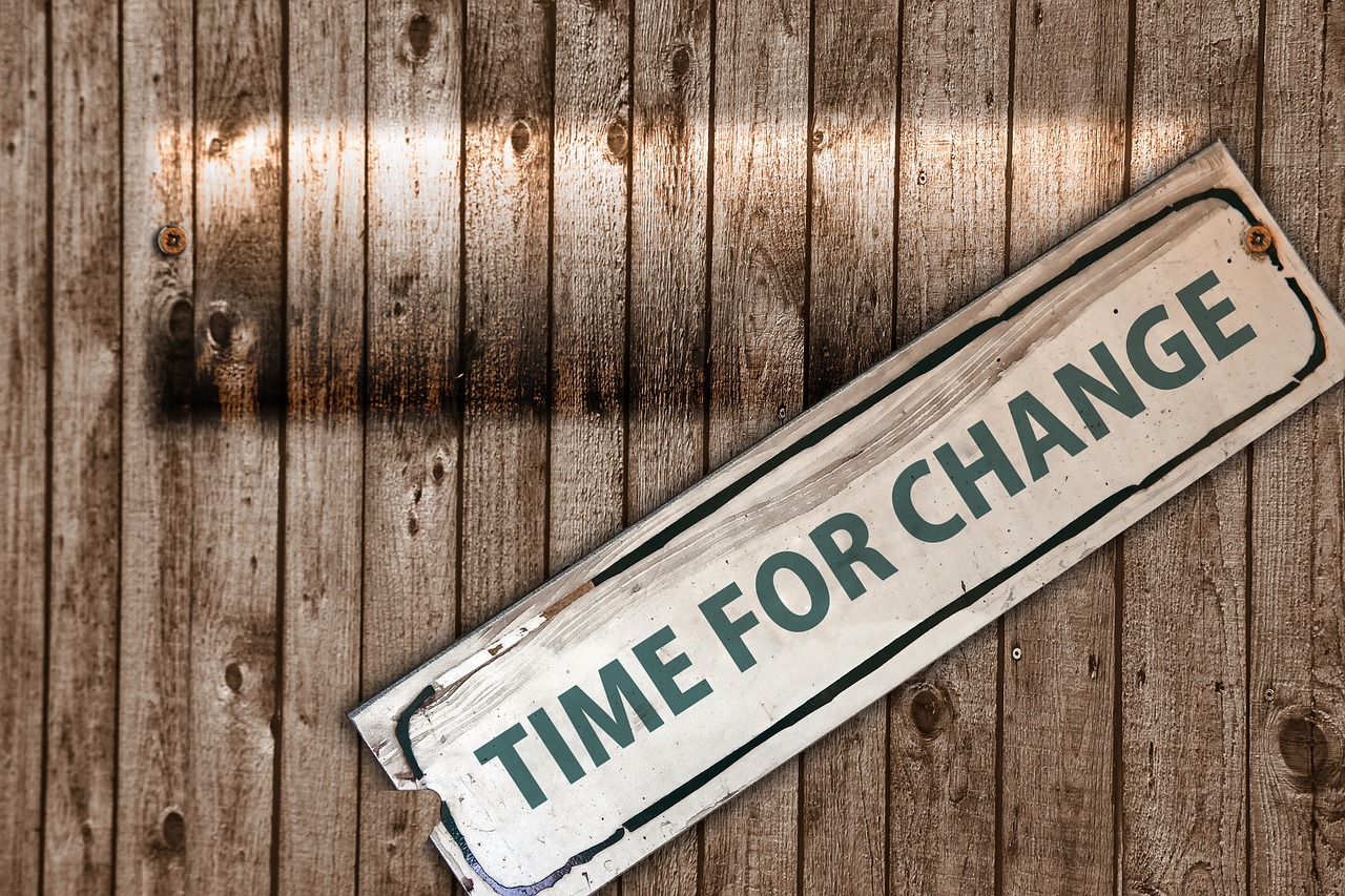 Sign reading 'Time for Change' on wooden background, symbolizing transformation and new beginnings.