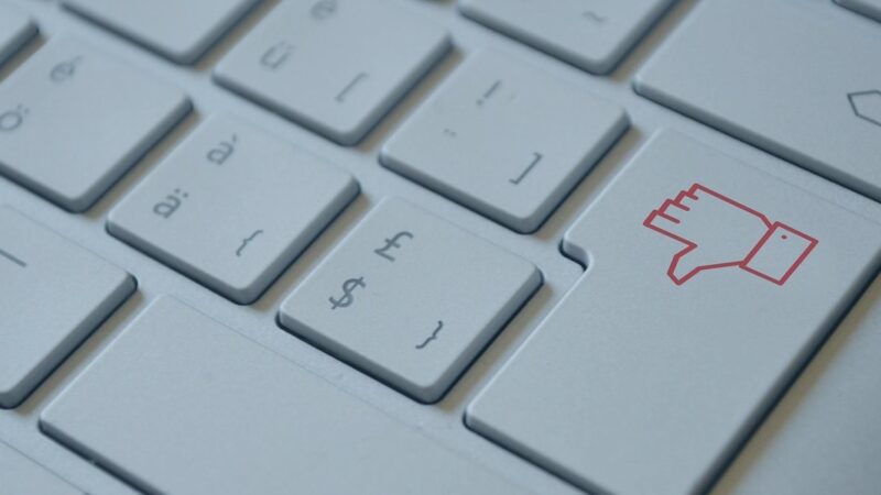 Close-up of keyboard with a thumbs down icon key on the right side.