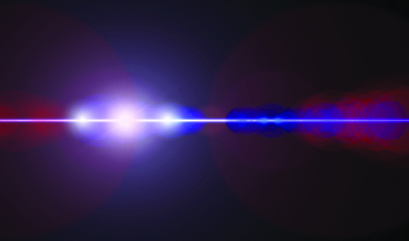 Bright lens flare with blue and red light beams on a dark background.