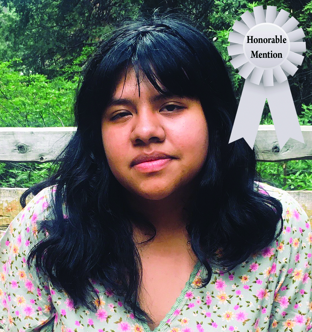 Young person outdoors with a floral top and an Honorable Mention ribbon.