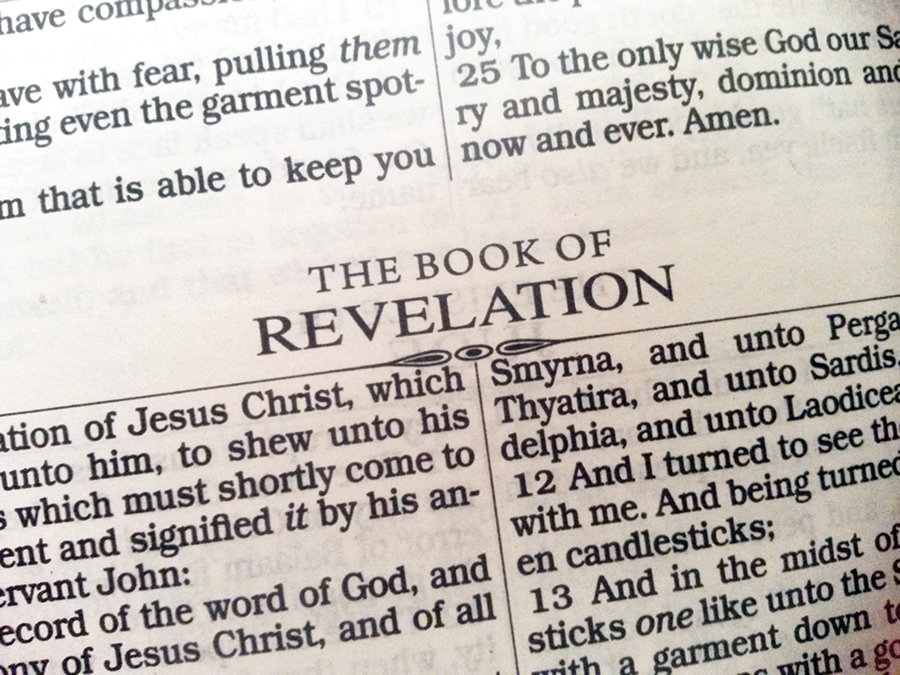 Open Bible page showing heading for the Book of Revelation with text references to Jesus Christ.