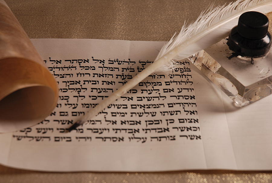 Ancient Hebrew scroll with quill and ink, symbolizing traditional writing and historical documentation.