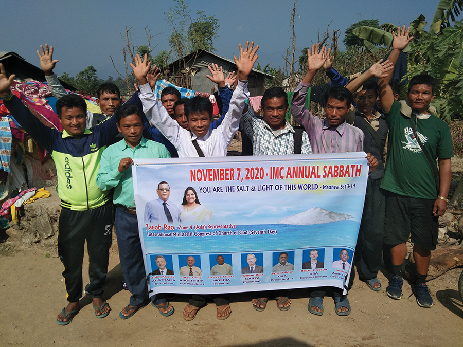 Group of people holding a banner for the IMC Annual Sabbath event, November 7, 2020, in an outdoor setting.