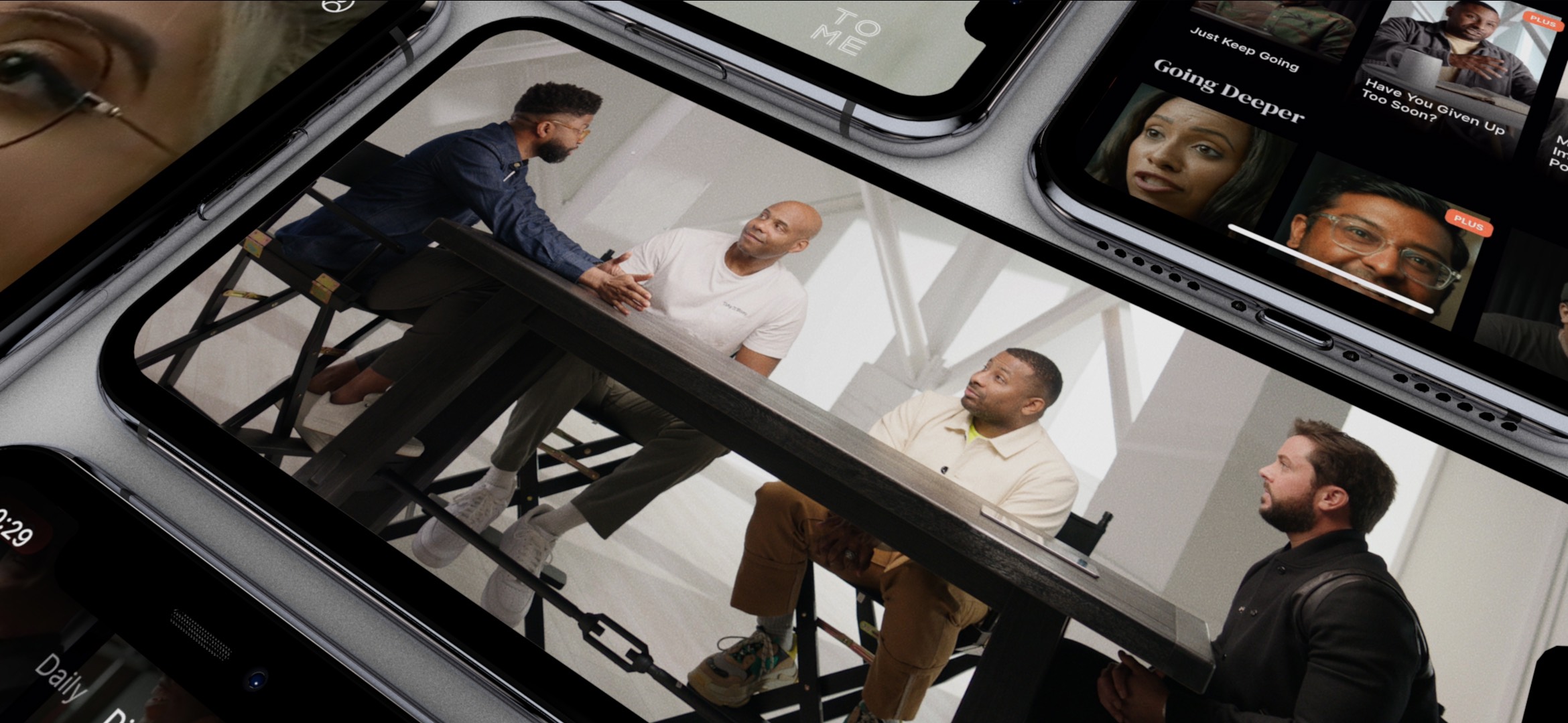 Group discussion at a table displayed on multiple smartphones, showcasing digital content streaming.