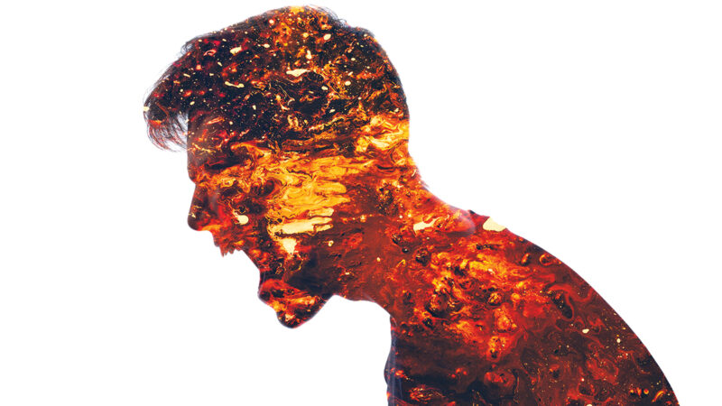Silhouette of a person filled with fiery textures, symbolizing intense emotion and inner energy.