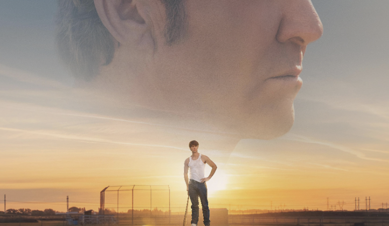Movie poster for The Hill with a man standing on a car at sunset, tagline Never give up hope.