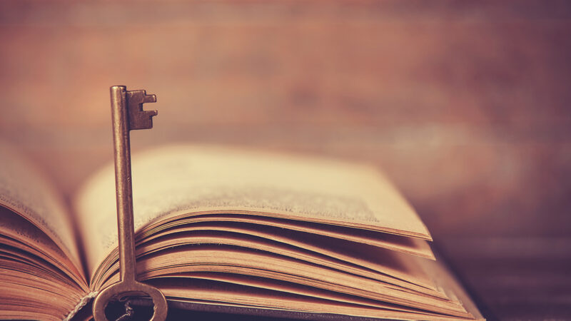 Retro key and opened book
